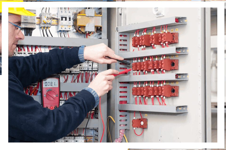 Electrician testing electrical panel wiring.
