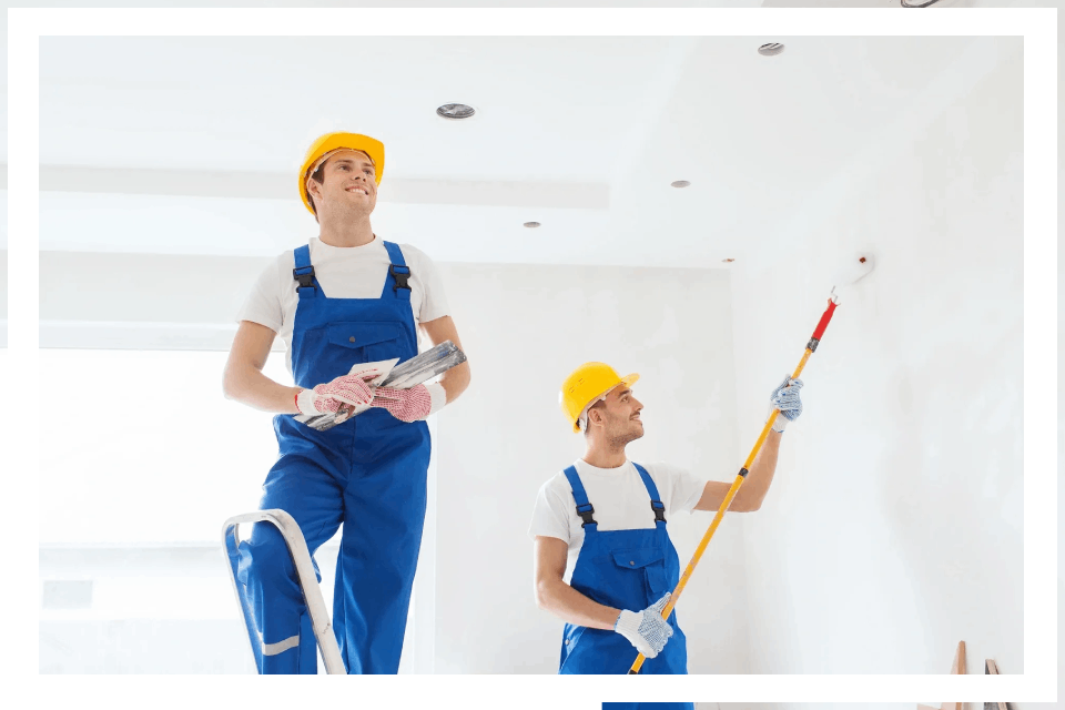 Painters working on interior wall painting.