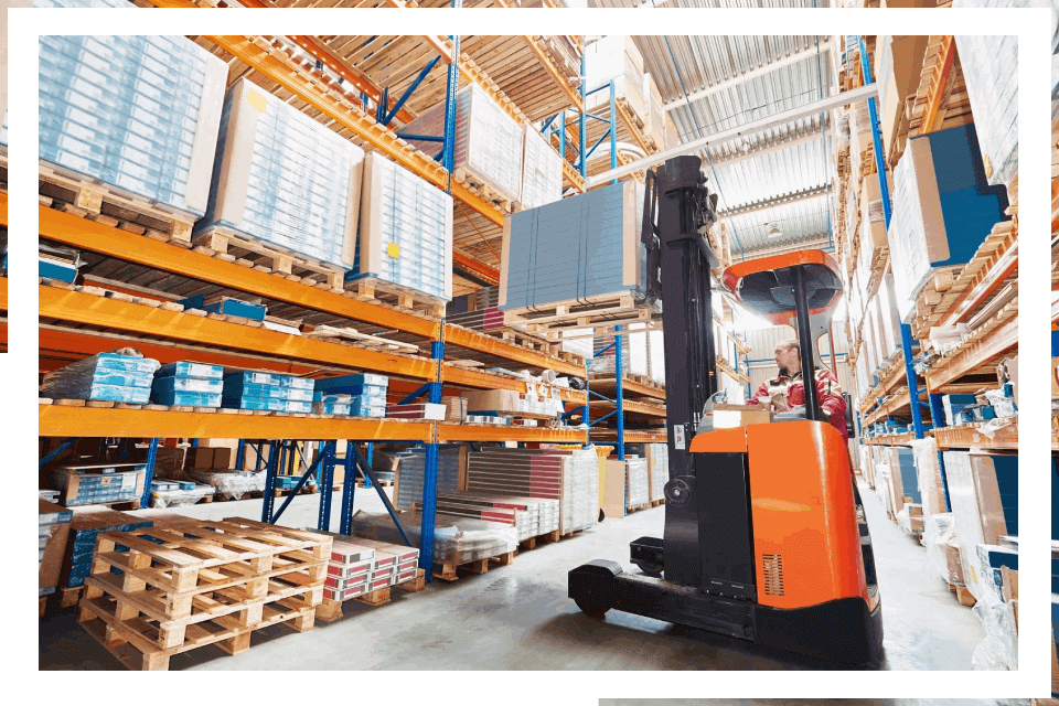 Forklift moving boxes in warehouse.